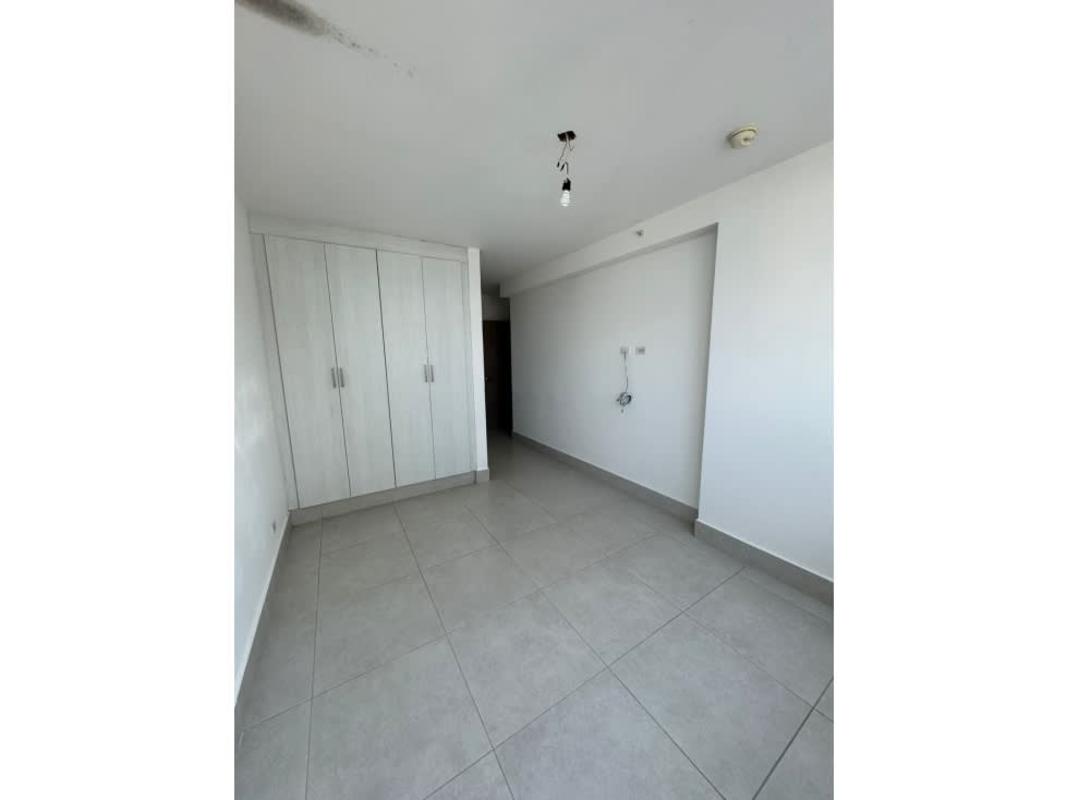 Empty bedroom with tile floors, large window and city view in PH Quadrat