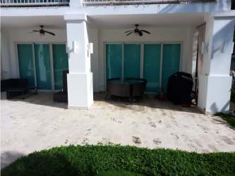 Covered outdoor patio with seating and ceiling fans in PH Bijao Residences Panama
