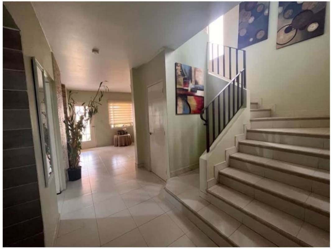 Dining area with bright windows facing backyard garden in Costa Sur house for sale Panama City