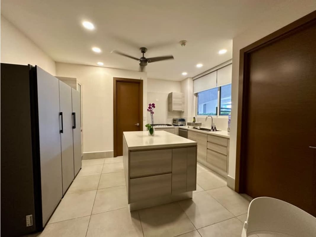 Spacious gourmet kitchen with island and granite countertops at The Reserve Santa Maria Panama