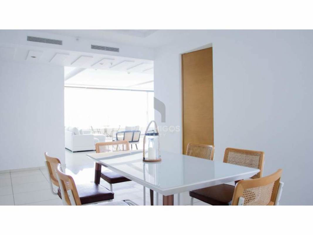 Dining area with large windows, modern furniture and ocean view in luxury condo Altamar Costa del Este Panama