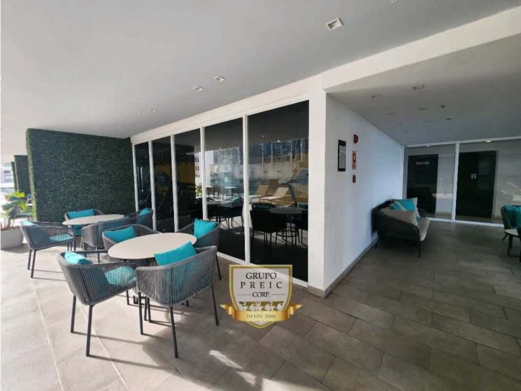 Private balcony with glass railing, overlooking Panama City skyline and partial ocean at PH GV 43