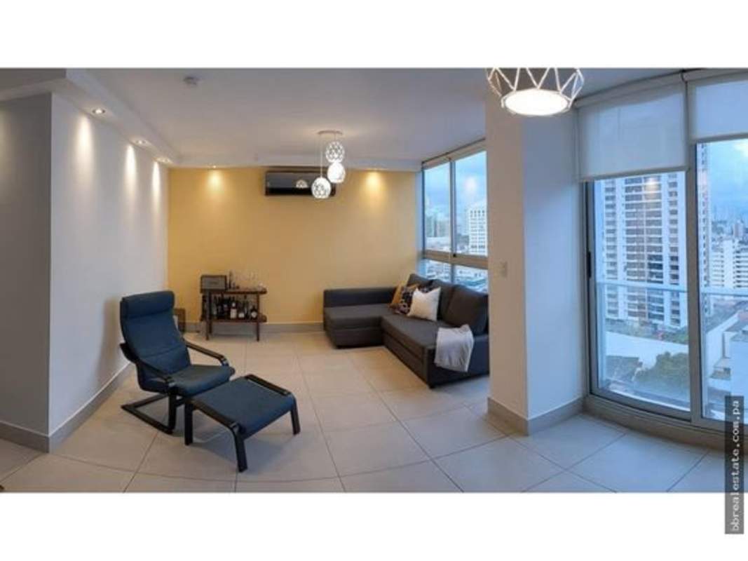 Living room with floor-to-ceiling windows, skyline view and modern furniture in PH Park City Panama