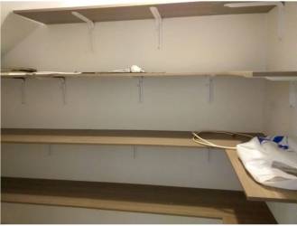 Covered outdoor terrace with tile floor in backyard of Panama Pacifico house for sale