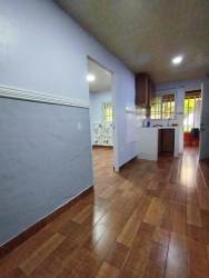 Apartment interior hallway with wood style flooring leading into small kitchen Villa Liriola Cativa Colón Panama