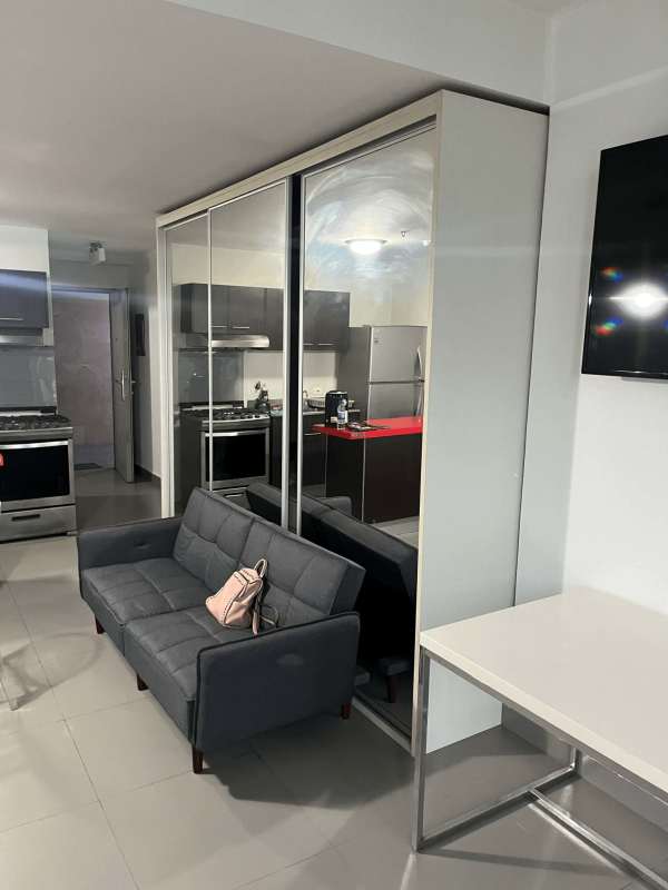 Modern furnished studio with bed, sofa, dining area, and balcony in PH Colores de Bella Vista Panama City