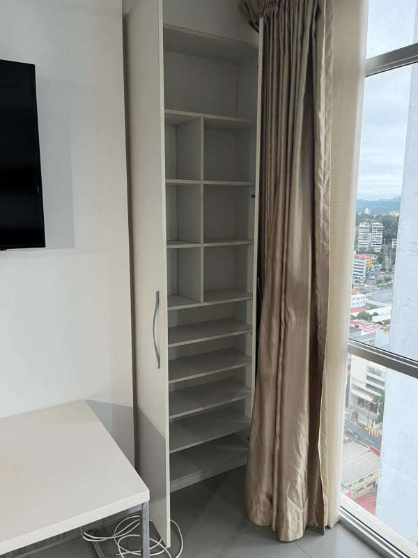 Modern condominium gym with cardio equipment, pool view at PH Colores de Bella Vista Panama