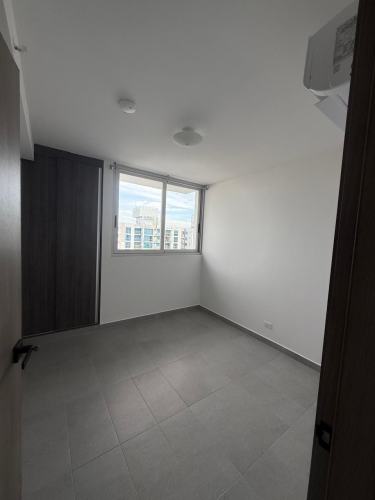 Modern bedroom with large window and wardrobe in apartment for rent Carrasquilla Panama