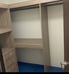 Spacious walk-in closet with wooden shelves and drawers PH Midtown Panama Pacifico for rent