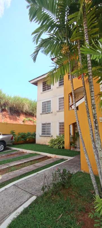 Three story Las Acacias apartment building gated parking and landscaping Panama City