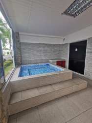 Living room with futon sofas, mounted TV and AC at Ibiza Beach Residences Bijao Panama