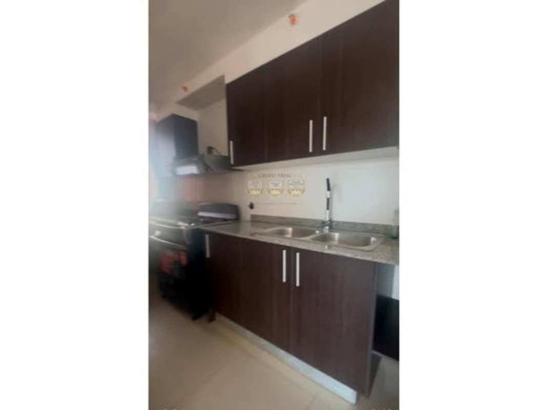 Kitchen with granite countertop and appliances included at PH Sky Park apartment