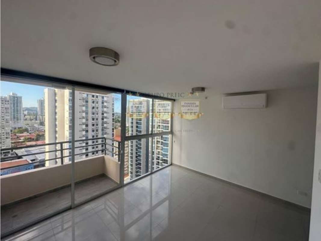 Open living and dining area with balcony and city view in PH Sky Park apartment Panama City