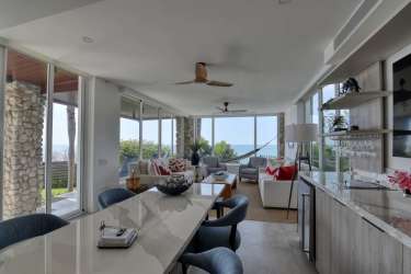 Modern open-concept living area with panoramic ocean views in luxury beachfront villa
