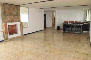Bright open-concept living and dining area with fireplace, tiled floors, and mountain views in El Valle Panama