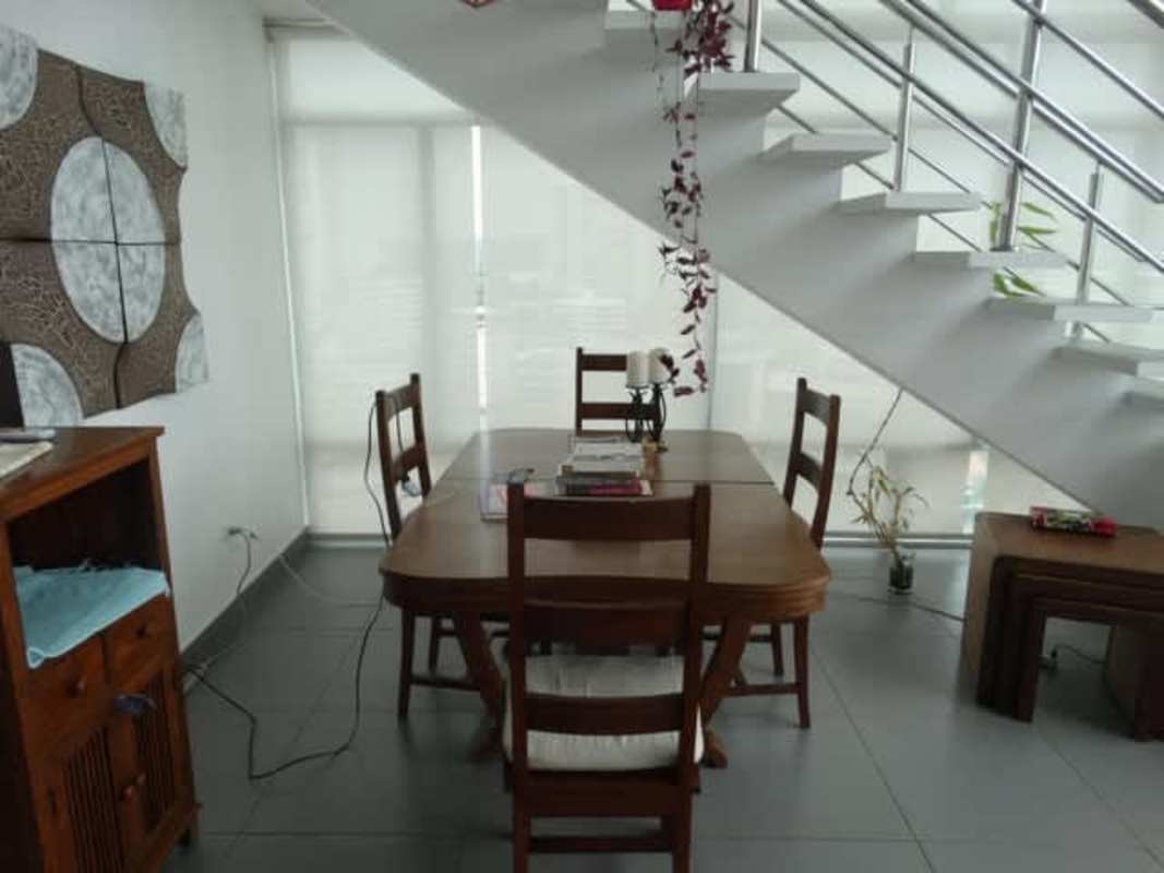 Loft-style bedroom overlooking lower level with large windows at PH Mediterraneo Loft El Cangrejo