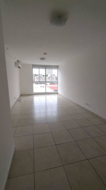 Bright living room with ceramic tiles and large window in Panama City apartment near 12 de Octubre Metro