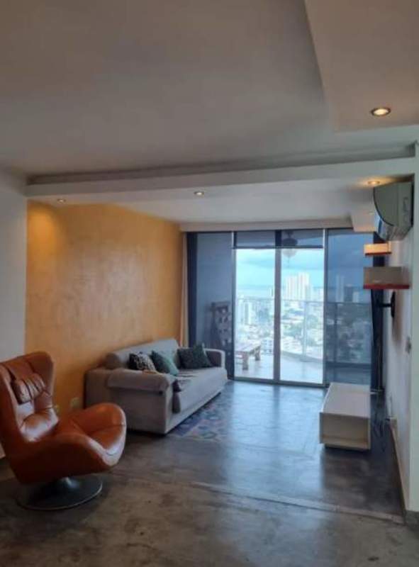 Living room with floor-to-ceiling windows, yellow accent wall, and city view at PH Park Lane Tower Hato Pintado Panama
