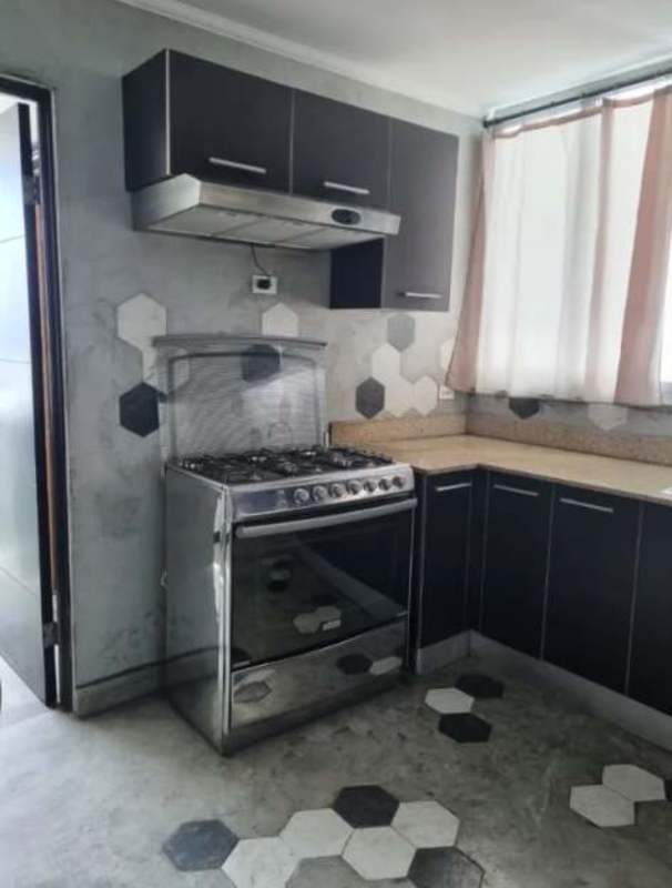 Modern kitchen featuring hexagon tile design, stainless steel appliances at PH Park Lane Tower Panama