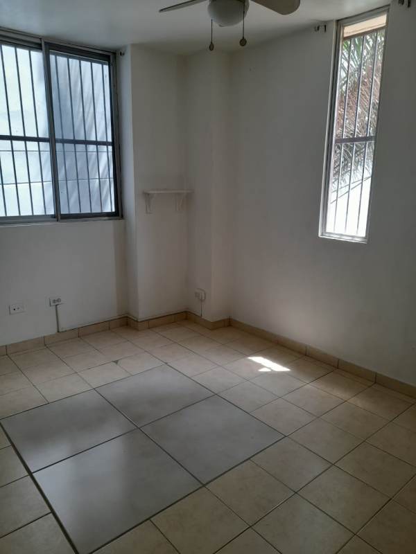 Open concept kitchen with granite countertop overlooking dining area in PH Altos de la Colina 12 de Octubre Panama