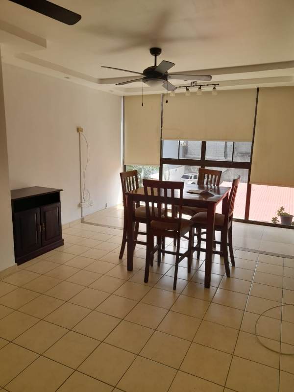 Modern kitchen with granite countertops, dark wood cabinets and appliances in PH Altos de la Colina 12 de Octubre Panama City