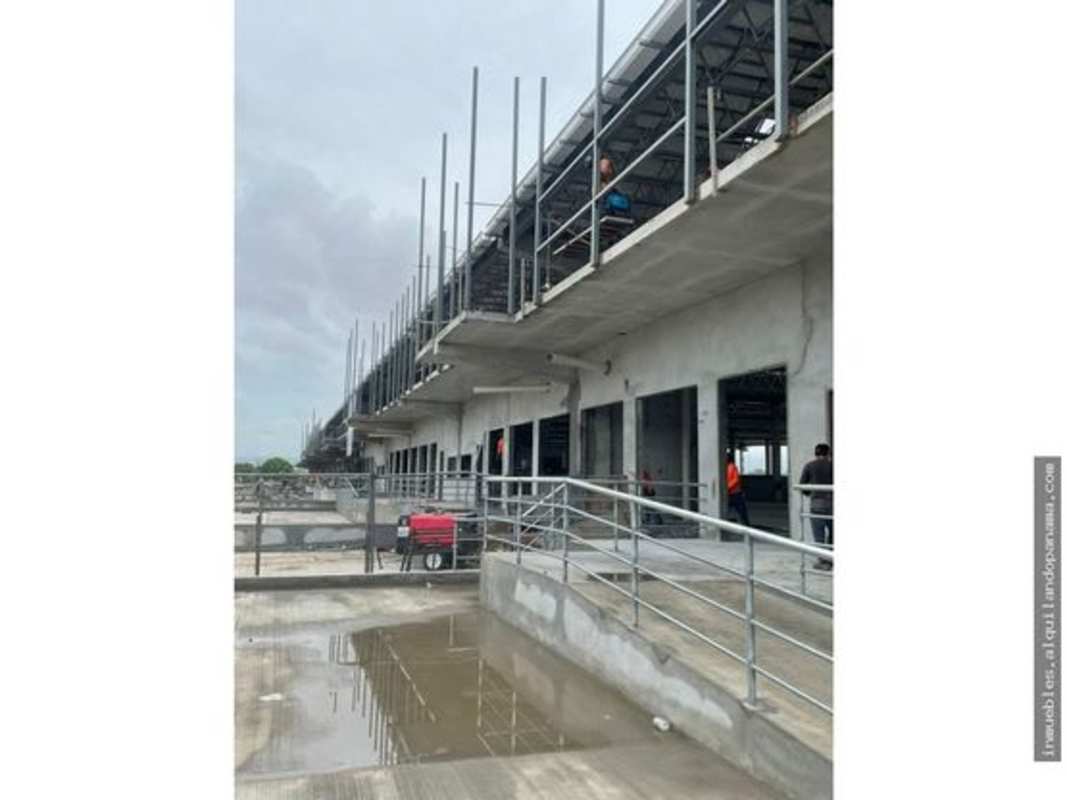 Commercial warehouse under construction with steel frames, open concrete area, Via Tocumen Panama