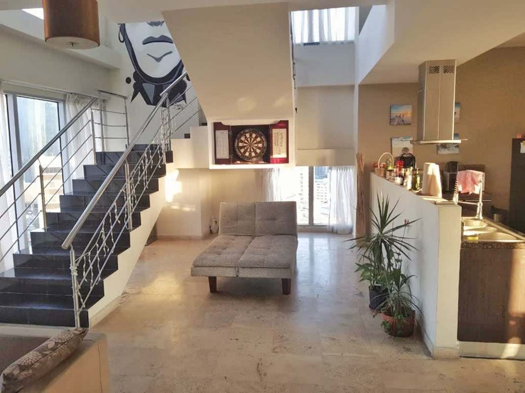 Loft style apartment with double height ceiling staircase open kitchen in PH Denovo Obarrio Panama