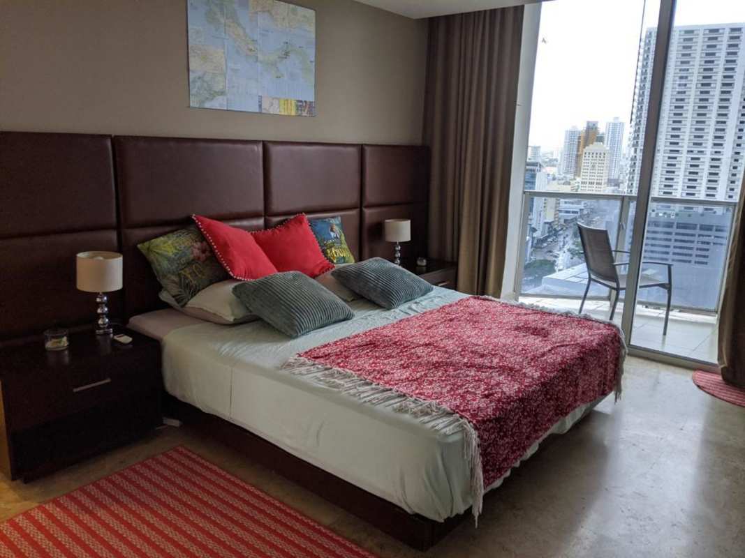 Contemporary bedroom with city views from the balcony in PH Denovo, Obarrio Panama City