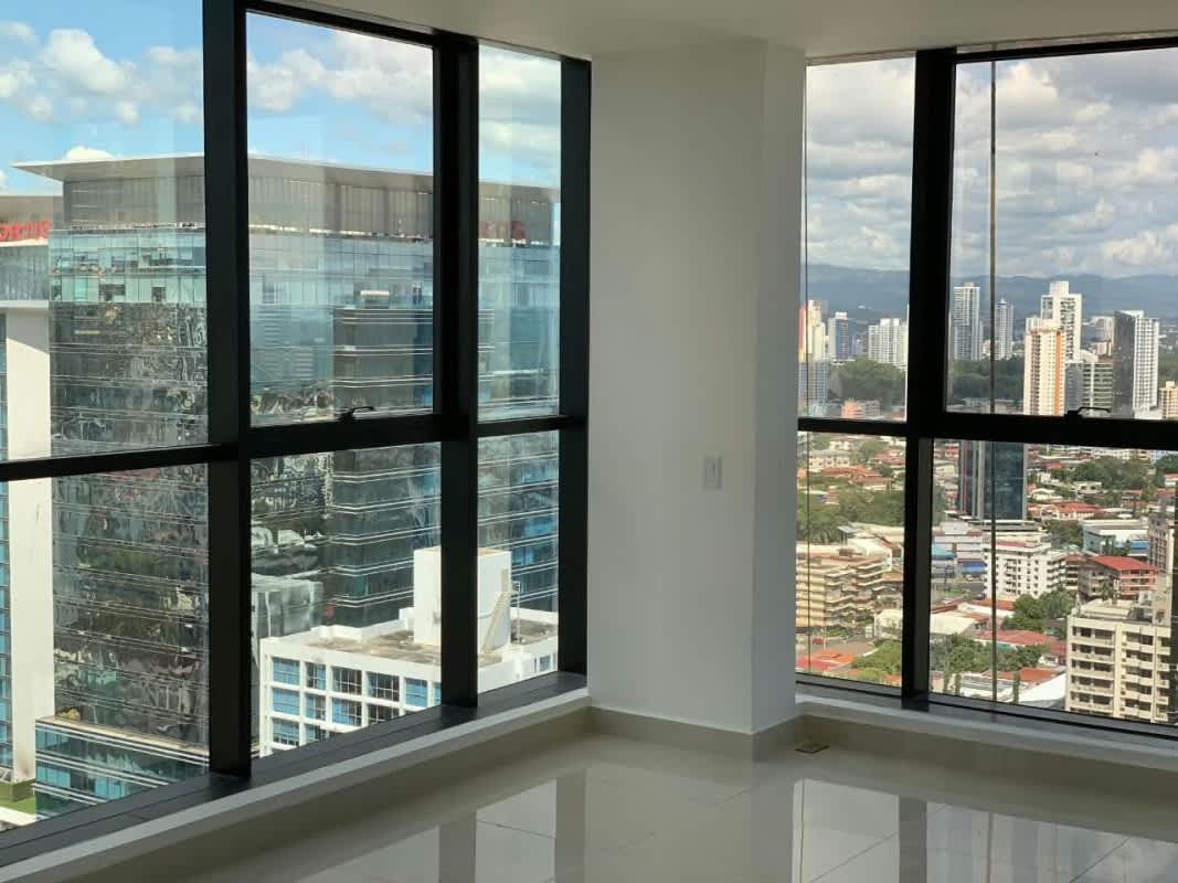 Bright apartment living area with large glass windows and skyline views Downtown Panama City