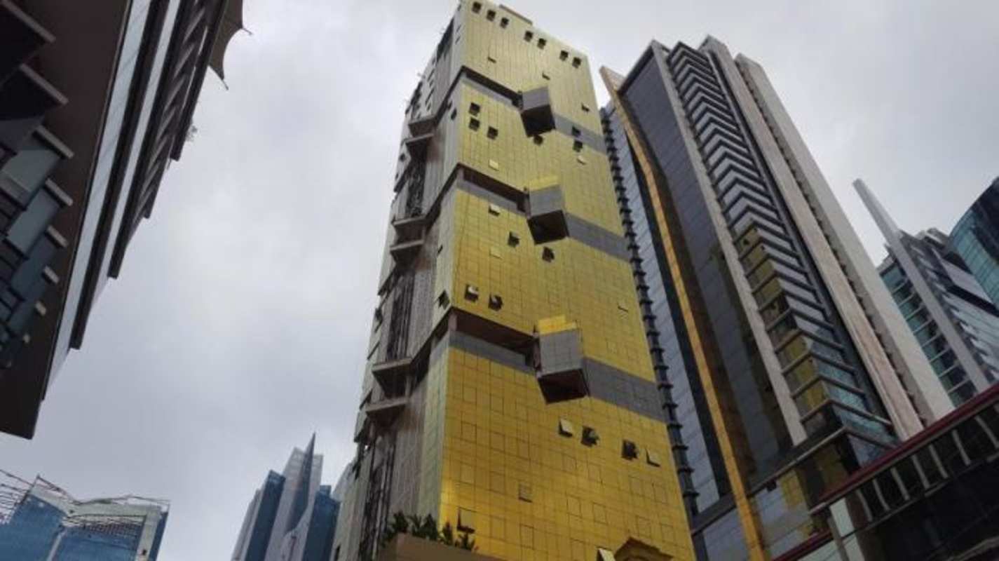 Iconic gold glass facade of PH Downtown Panama high-rise tower in financial district