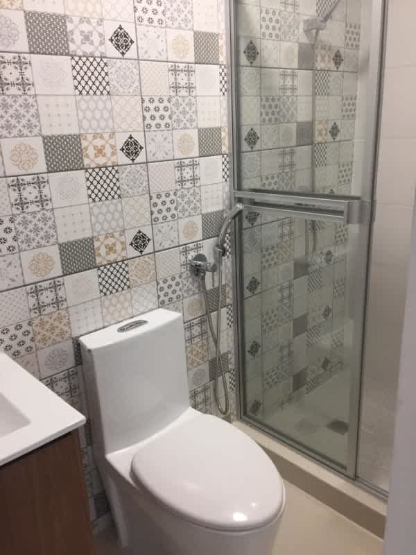 Stylish contemporary bathroom with decorative tile and glass shower enclosure downtown Panama