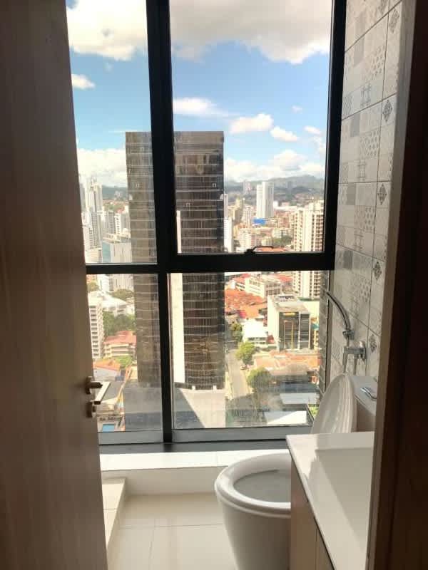 Modern bathroom with city view window decorative tiles PH Downtown Panama City
