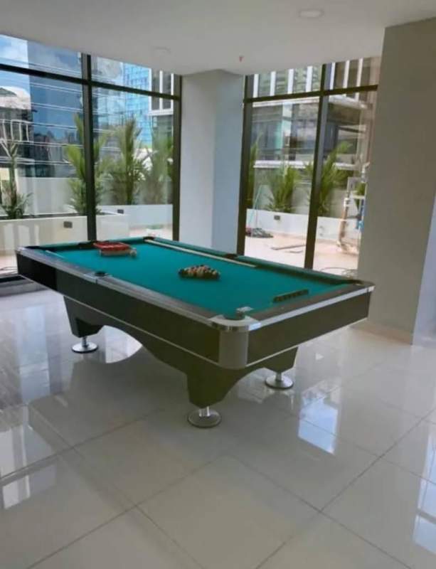Modern game room with billiards table overlooking city skyline PH Downtown Panama