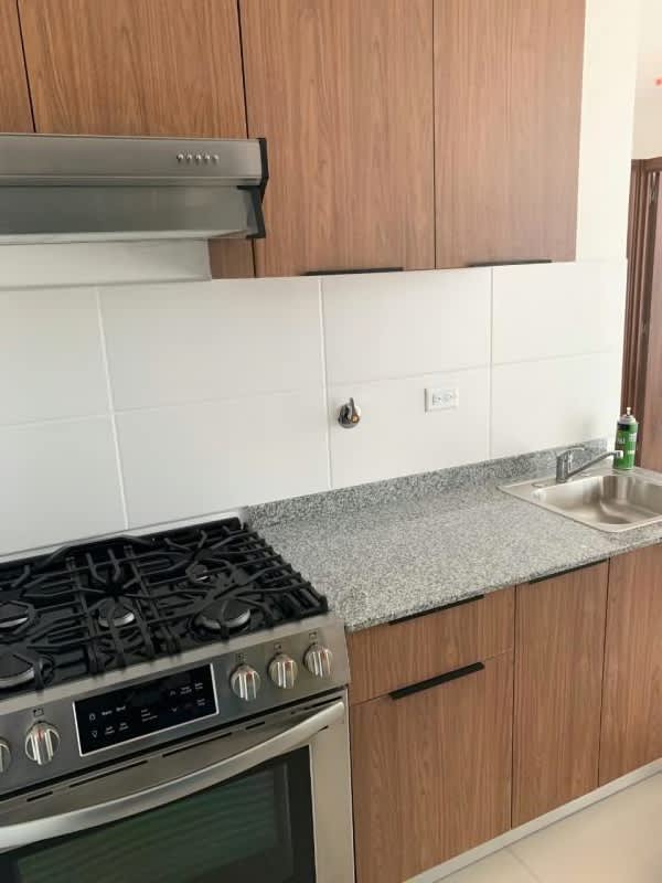 Contemporary kitchen with granite countertop and gas stove in apartment Panama City