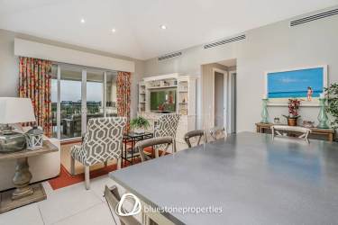 Bright open living area opening to private balcony overlooking lake Lagos Buenaventura Panama