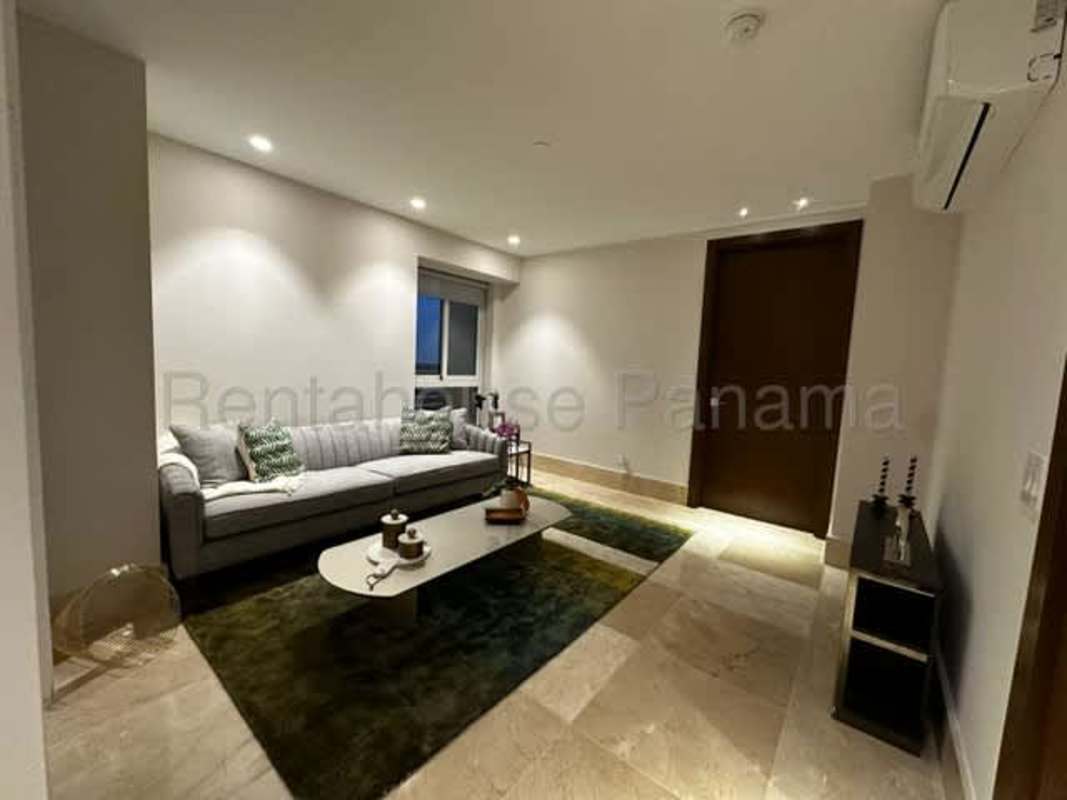 Large covered balcony with city skyline and garden views in PH The Reserve Santa María Panama City