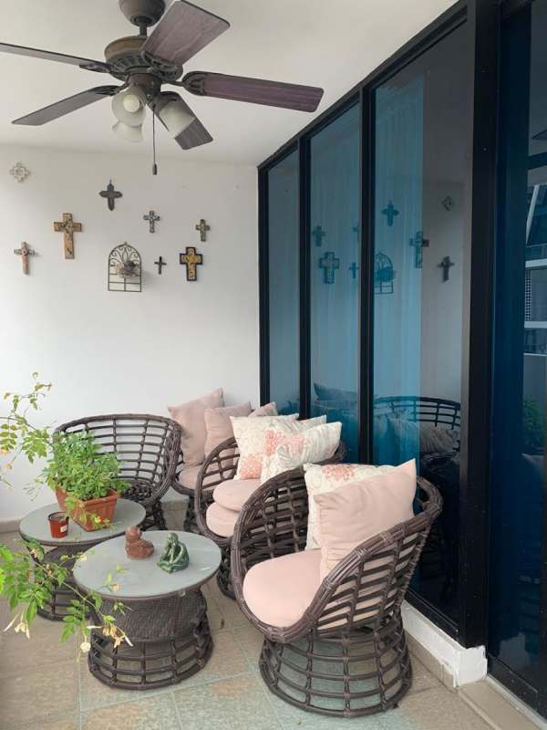 Enclosed balcony with seating area, ceiling fan, large glass windows in PH Mirador del Parque San Francisco Panama