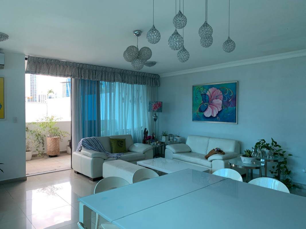 Bright hallway with modern decor, leading to spacious living-dining room PH Mirador del Parque Panama City