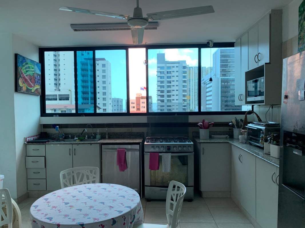 Modern kitchen with granite counters, large windows cityscape in PH Mirador del Parque San Francisco Panama