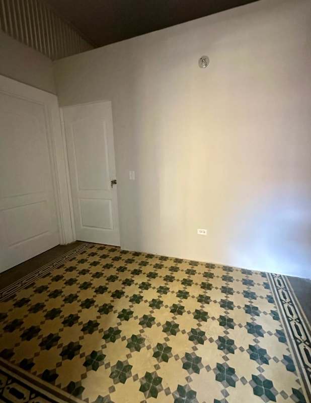 Traditional bedroom with patterned tile floor and natural light in El Dorado building Panama City