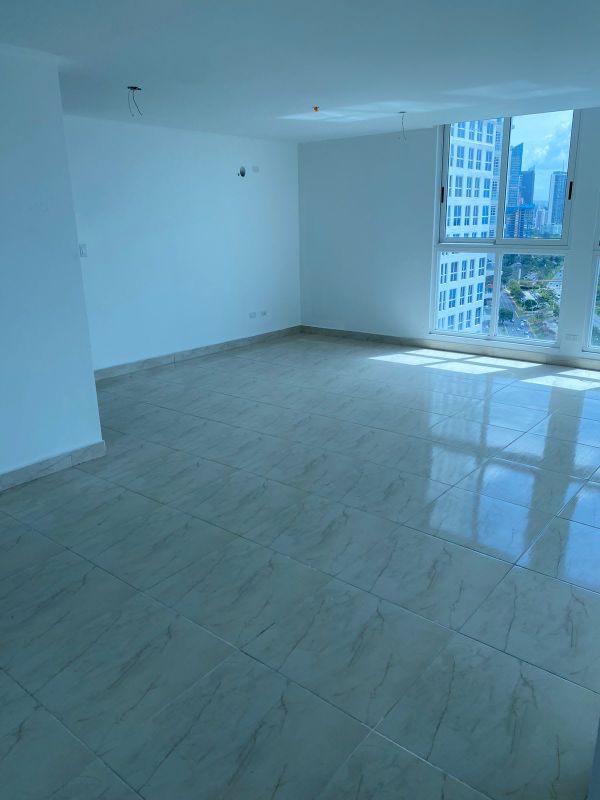 Spacious unfurnished living room with large windows and tiled floor at PH The Sands Panama City