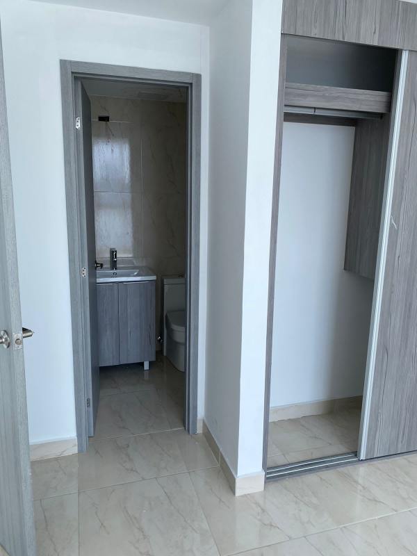 Bright bedroom with large window featuring city and ocean views in PH The Sands Panama