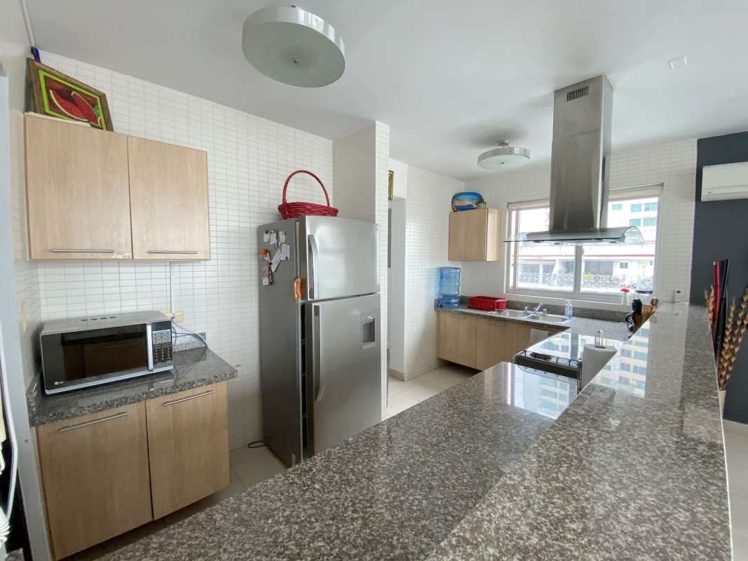 Large living room with dining area, full height windows and balcony in PH Tao Panama