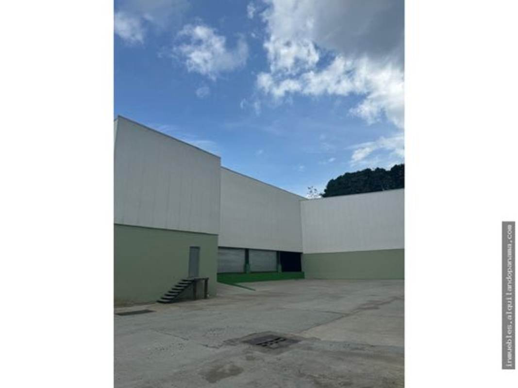 Front view modern industrial warehouse facade with parking and loading zone Las Mañanitas Panama