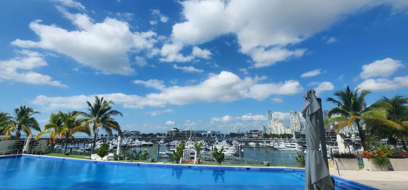 Glass dining table overlooking marina yachts Beach Club Residences Panama