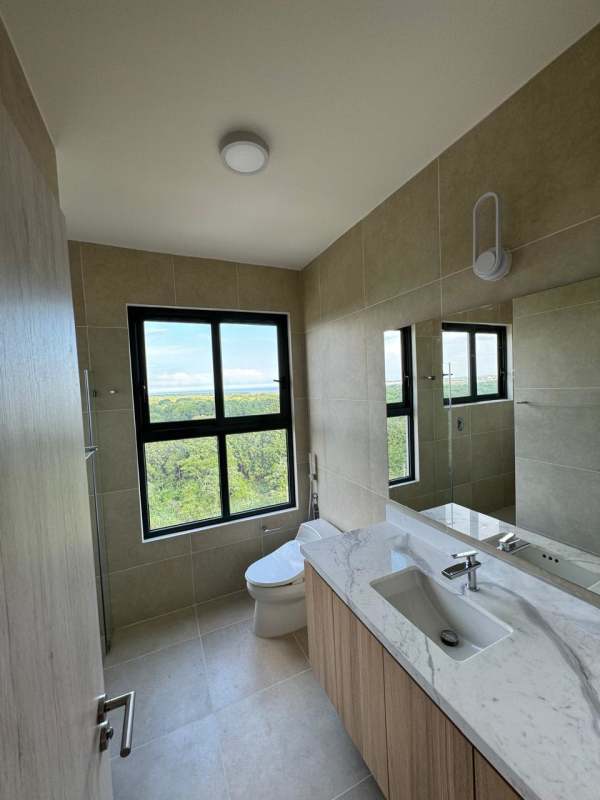 Secondary bathroom with elegant tile and glass shower Ocean House Santa María Panama
