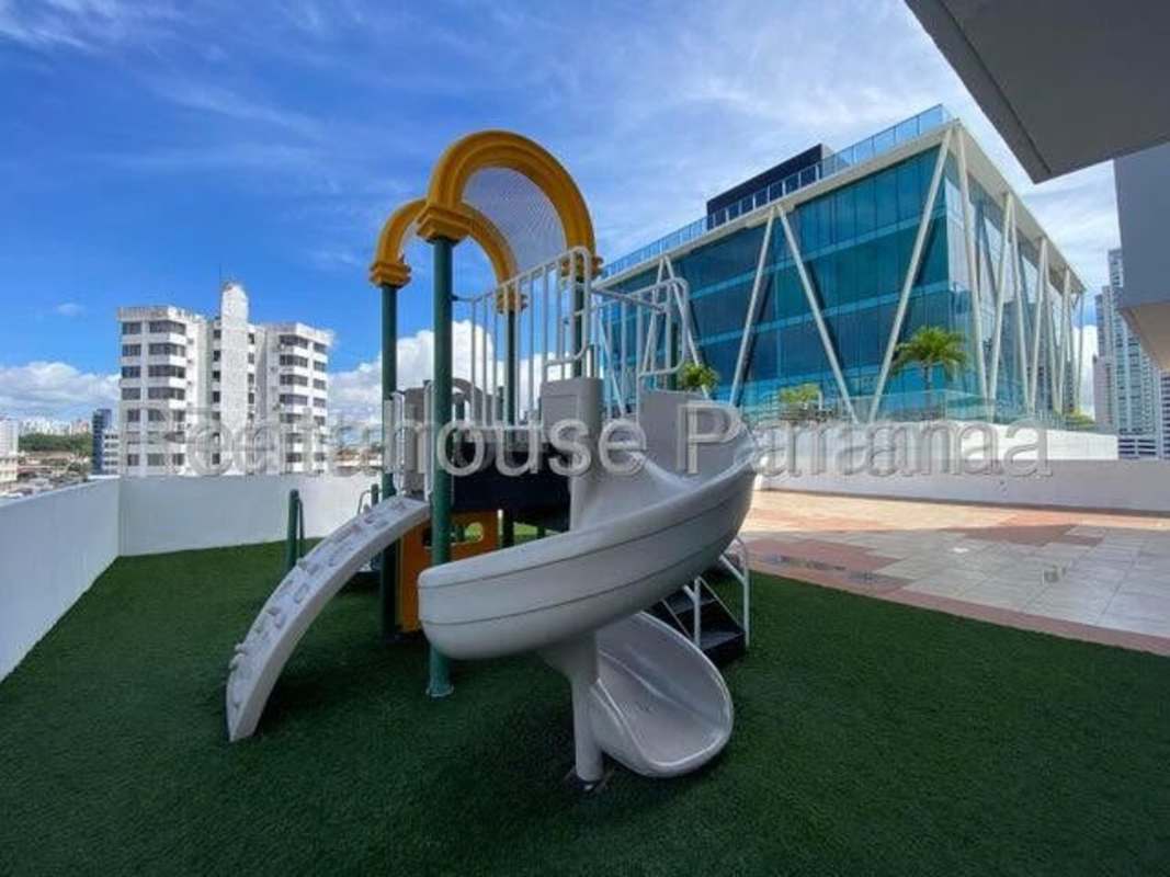 Rooftop playground with slide, city backdrop in PH San Francisco Bay Panama