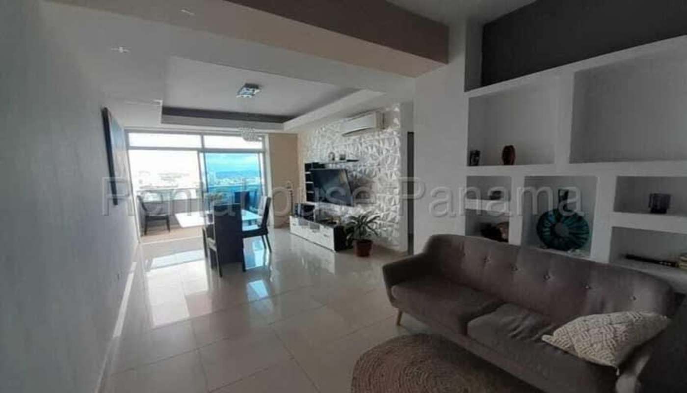 Living room with large windows, ocean and skyline views Panama apartment