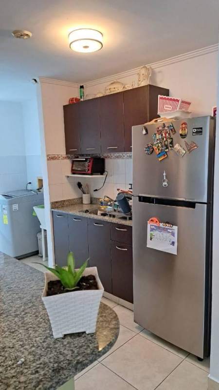 Kitchen with granite countertop, cabinets and natural light at PH Palmeras Panama City