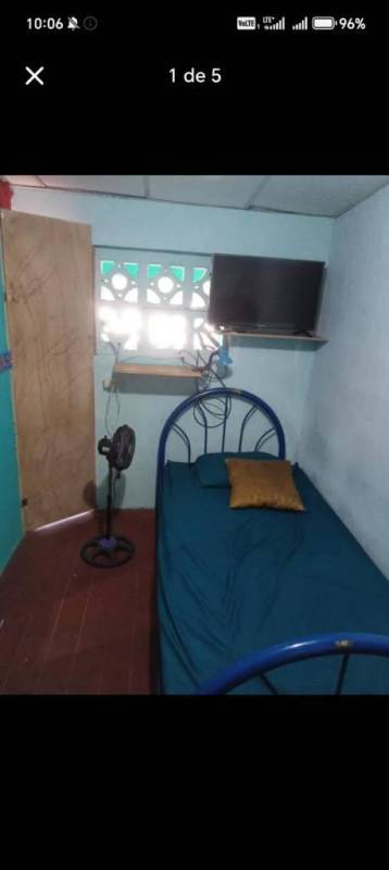 Small enclosed balcony with wooden walls, desk, and chair ideal for workspace private rental in Carrasquilla Panama